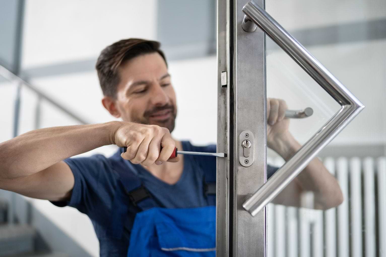 Portrait Young Male Carpenter Locksmith Repairing Door Lock