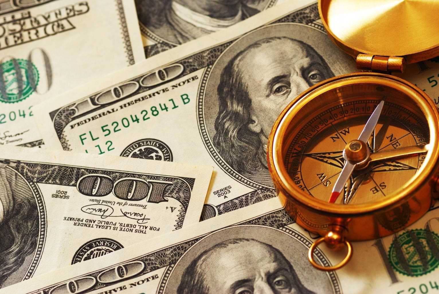 Compass Layed On Money