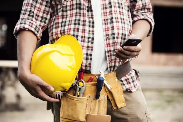 worker with a helmet and a mobile phone