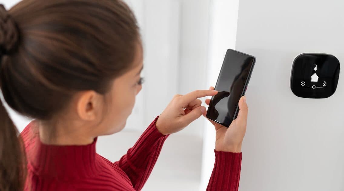 Woman With Hvac Thermostat 1 Aspect Ratio 1472 816
